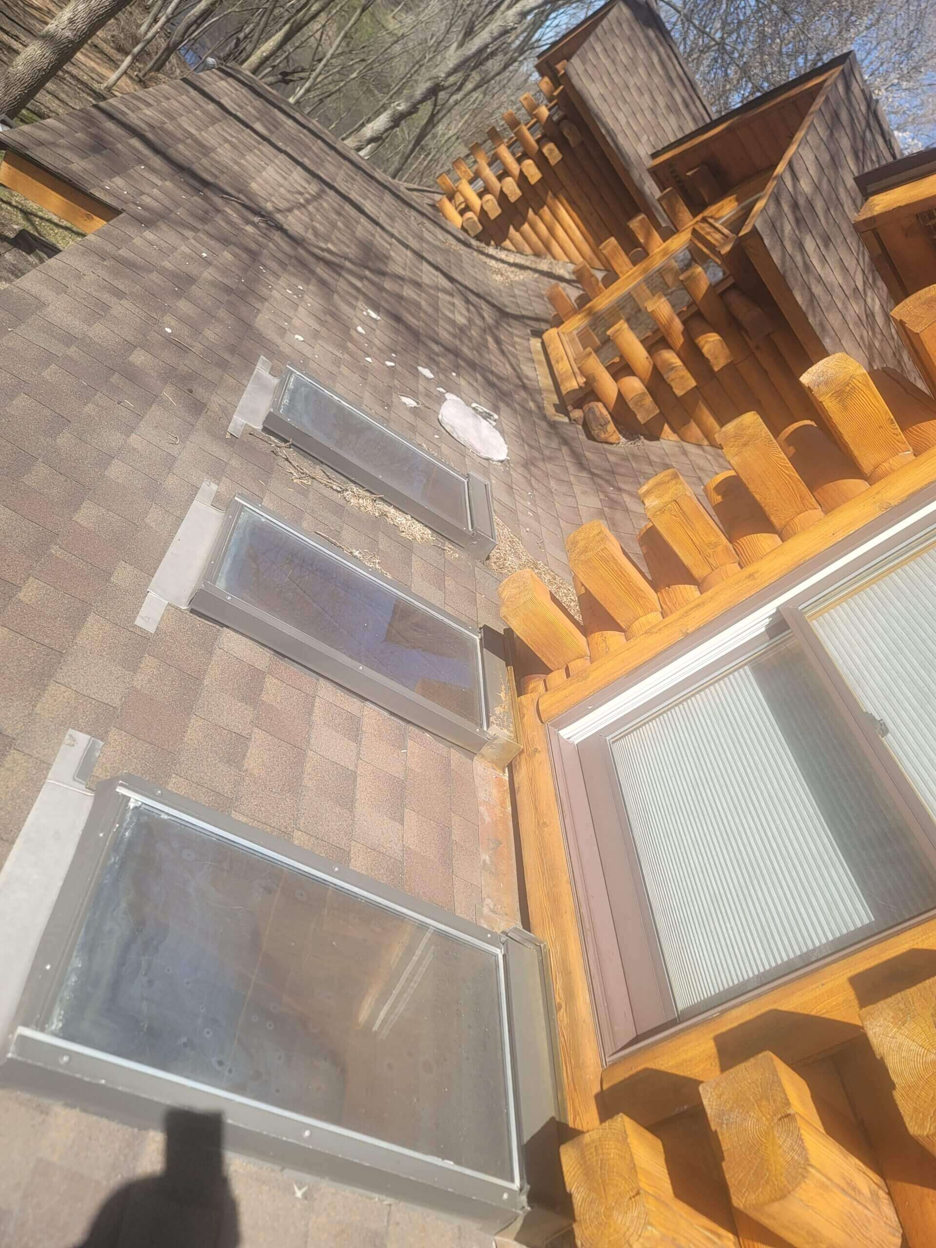 Wooden cabin roof with skylights and railing