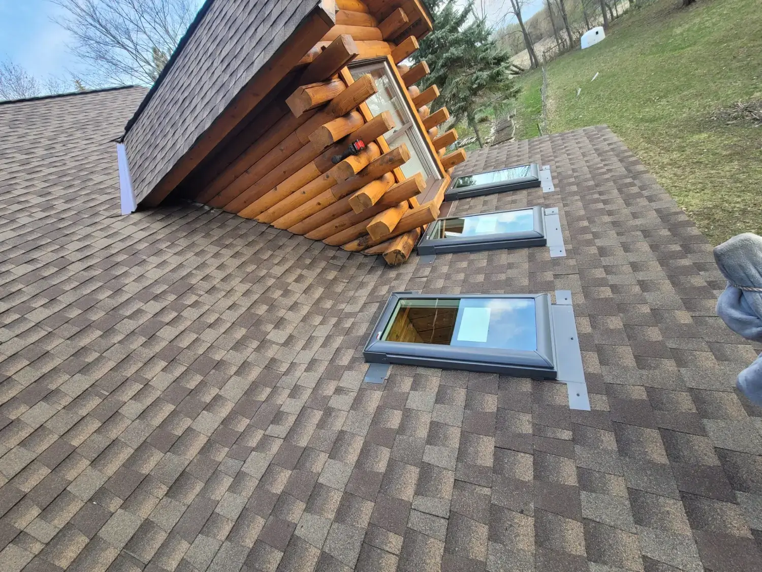 Skylights on brown shingled roof.